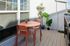 Charming balcony with stylish orange furniture and lush green plants, perfect for relaxation or entertaining.