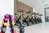 Modern fitness studio featuring sleek spin bikes, vibrant dumbbells, and a 20-pound kettlebell, perfect for an active lifestyle.