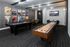 Chic entertainment room featuring modern shuffleboard, pool table, foosball, and stylish wall art.