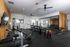 Modern fitness center with state-of-the-art gym equipment, free weights, and mirrors for an enhanced workout experience.