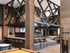 Luxurious modern lounge area with wooden beams, stylish bar seating, multiple flat-screen TVs, and a pool table, creating a perfect entertainment space.