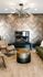 Modern living area with a sleek fireplace, stylish chandelier, and luxurious seating on elegant wood flooring.