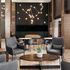 Luxurious apartment lounge with chic armchairs, modern lighting, and a stylish pool table.