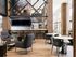 Chic and inviting common area with modern seating, sleek bar stools, and ample natural light, perfect for socializing or relaxation.