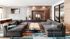 Modern living room with plush grey sofas, artistic accent wall, and a contemporary fireplace, creating a cozy and stylish ambiance.