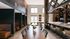 Modern community space with stylish seating, large dining table, and elegant lighting, ideal for social gatherings.
