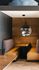 Chic dining nook with cozy leather seating, wooden accents, and stylish pendant lighting for a modern vibe.
