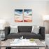 Modern living room with a sleek grey sofa, abstract art, and stylish decor creating a cozy and inviting atmosphere.
