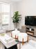 Bright and inviting living room featuring a modern TV setup, plush seating, and elegant decor, perfect for relaxation and entertainment.