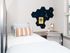 Cozy bedroom with stylish decor, featuring a comfortable bed, a modern desk with a chic gold lamp, and an eye-catching hexagonal wall decoration.