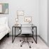 Chic and minimalist bedroom corner with a cozy bed, stylish desk, modern chair, and elegant wall art.