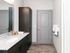 Modern bathroom featuring sleek wood cabinetry, a gleaming granite countertop, and an inviting neutral palette.