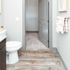 Bright modern bathroom with sleek fixtures, elegant countertops, and an inviting walk-in closet.