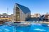 Modern apartment complex featuring a striking gable-roofed clubhouse and a refreshing outdoor swimming pool, perfect for leisure and relaxation.