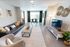 Modern living room with sleek leather sofa, contemporary decor, and large windows offering ample natural light.