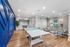 Modern recreational room featuring a ping pong table, foosball, vibrant wall art, and chic seating area with a contemporary design.