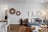 Chic living room with a modern gray sofa, stylish wall art, and cozy decor, perfect for relaxation and entertaining.