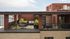 Chic rooftop patio with lush greenery and modern seating, perfect for entertaining or relaxing in a stylish urban setting.