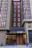 Contemporary urban apartment exterior with stylish brick and panel design at Hub building entrance.