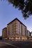 Stunning contemporary apartment building illuminated at dusk, showcasing elegant architecture and urban sophistication.