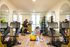 Modern fitness center with state-of-the-art equipment, featuring exercise bikes and a vibrant stretching area with colorful exercise balls and mirrors.