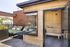 Luxurious rooftop terrace with a cozy outdoor sauna, stylish wooden decking, and comfortable lounge chairs offering scenic views.