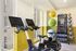 Modern fitness room featuring high-tech exercise bikes, vibrant exercise balls, and sleek workout equipment for a complete home gym experience.