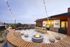 Chic rooftop terrace with modern seating, cozy fire pit, and ambient string lights, offering stunning views.