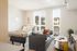 Bright and cozy studio apartment featuring a comfy bed, modern sofa, and stylish decor with scenic views from large windows.