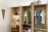 Inviting study nook with a neatly organized wardrobe, cozy lamp, and stylish decor for a perfect study space.