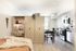 Modern studio apartment with sleek kitchen, cozy workspace, and inviting open-concept living area.