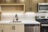 Modern kitchen design with sleek stainless steel appliances, elegant cabinetry, and a contemporary faucet over a spacious sink.