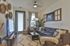 Chic and cozy living room with stylish decor, featuring a plush sectional sofa, wall art, and warm, natural lighting.