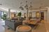 Modern, spacious living area with chic lighting, cozy gray sofas, and stylish decor, perfect for relaxation and entertaining.