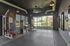 Modern apartment gym with state-of-the-art fitness equipment, large windows, and sleek interior design.