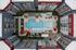 Stunning aerial view of a modern apartment complex with a central pool, lush greenery, and inviting patio areas with red umbrellas.