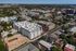 Vibrant aerial view of a modern urban neighborhood showcasing stylish architecture and lush greenery, ideal for city living.