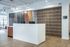 Modern and stylish lobby area featuring a sleek reception desk with wood and industrial design elements at Hilltop Apartments.