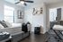 Bright bedroom with modern decor, featuring a cozy bed, stylish artwork, and a spacious desk area for productivity.