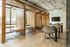 Modern communal area with stylish wood dividers and cozy seating, perfect for work or relaxation.