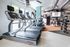 Modern fitness center with state-of-the-art treadmills, vibrant decor, and ample natural light.