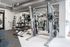 Modern fitness center featuring state-of-the-art weight training equipment and sleek interior design.