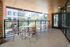 Charming urban balcony with stylish seating, offering a scenic city view, ideal for outdoor relaxation or casual dining.