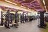 Modern fitness center with state-of-the-art gym equipment and vibrant purple lighting, perfect for intense workouts.