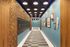 Chic hallway with modern lighting, art decor, and intricate wood paneling accentuating stylish mailbox design.