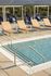 Luxurious rooftop pool area with stylish lounge chairs and breathtaking mountain views.