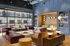 Modern lounge area with sleek furniture, large windows, and vibrant decor, offering a luxurious and inviting ambiance.
