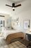 Modern bedroom with stylish decor, cozy bed, and a well-lit workspace; perfect for comfort and productivity.