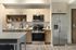 Modern kitchen with sleek stainless steel appliances, chic wooden cabinets, and elegant open shelving.