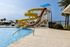 Clubhouse with resort style pool, seating, and water slides